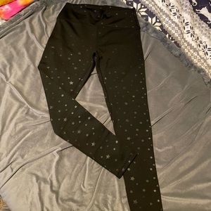 Black leggings with star details on them